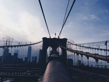 Bridge over river against cloudy sky