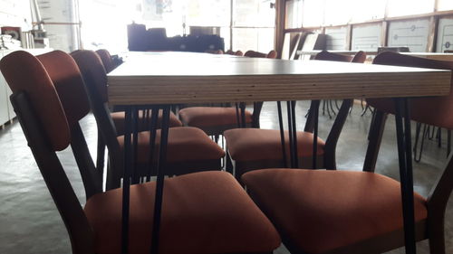 Empty chairs arranged in row
