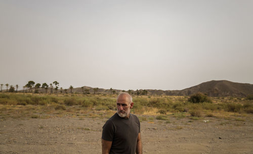 Adult man in tabernas desert, almeria, spain, in summer