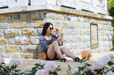 Young happy business woman relaxing in city, park. using phone. selfie. technology. summer vacation