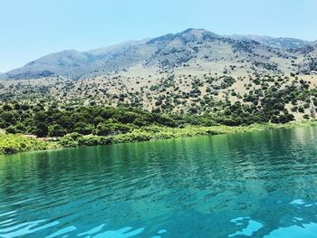 Scenic view of lake against clear blue sky