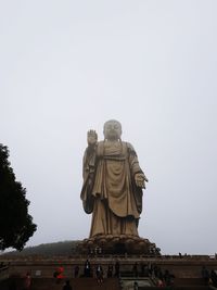 Low angle view of statue against sky