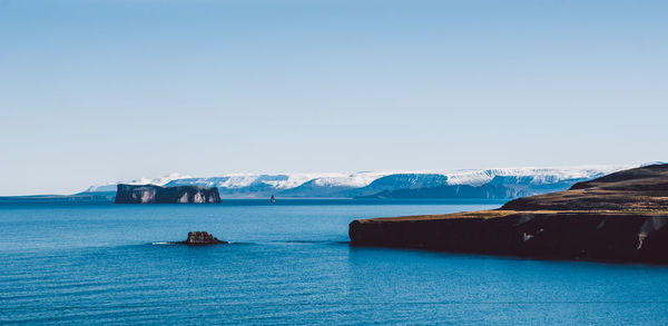 Scenic view of sea against clear blue sky