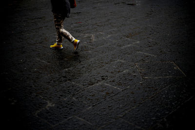 Low section of man with umbrella on floor