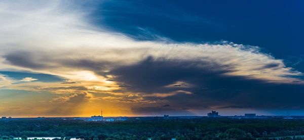 Scenic view of field against dramatic sky