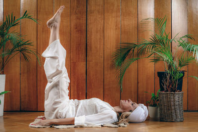 Woman practicing kundalini yoga, kriya exercises for the navel center and bowel waste elimination