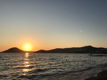 Scenic view of sea against clear sky during sunset