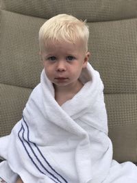 Portrait of boy wearing white towel