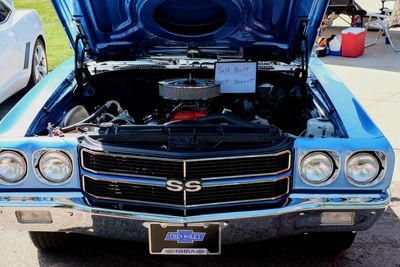 Close-up of vintage car parked against blue sky