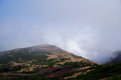 Scenic view of volcanic mountain against sky