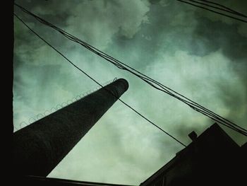 Low angle view of building against cloudy sky