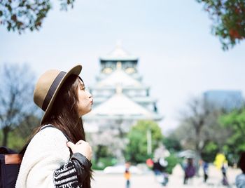 Side view of young woman puckering