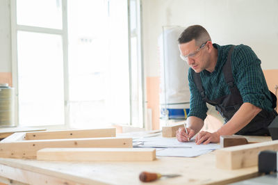 Side view of man working at office