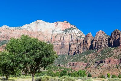 Scenic view of rocky mountains against clear blue sky