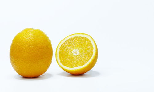 Close-up of oranges against white background