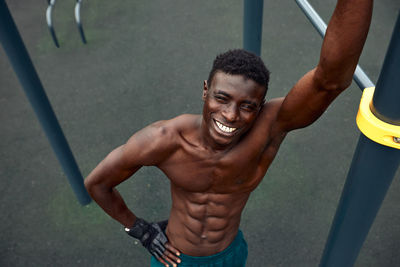 Portrait of young man exercising in playground