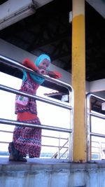 Low angle view of worker working on window