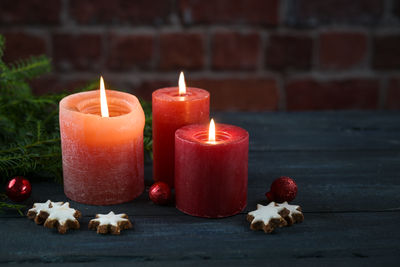 Close-up of illuminated candles on table