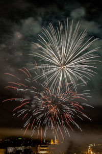 Low angle view of firework display at night