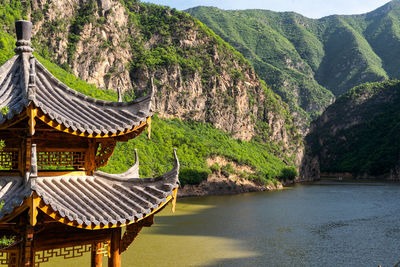 Scenic view of river with mountain in background