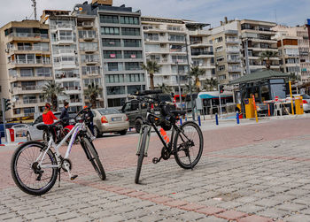 Bicycles parked on street against buildings in city