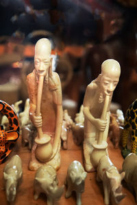 Close-up of statues on table at store