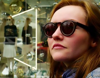 Close-up of beautiful woman against window display