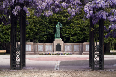 View of cross on footpath in park