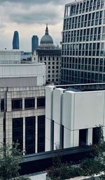 Modern buildings against cloudy sky