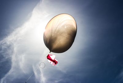 Low angle view of balloons against sky