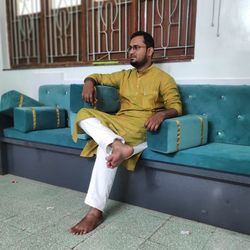 Young man sitting on sofa