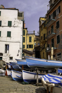 Fishing boats with colorful traditional houses - riomaggiore, cinque terre, italy