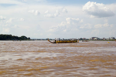 Boat sailing in sea against sky