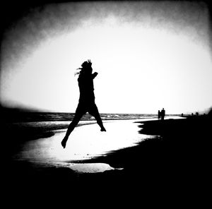 Silhouette people on beach