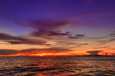 Scenic view of sea against dramatic sky during sunset