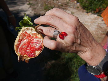 Close-up of hand holding strawberry