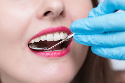 Close-up of dentist examining patient teeth