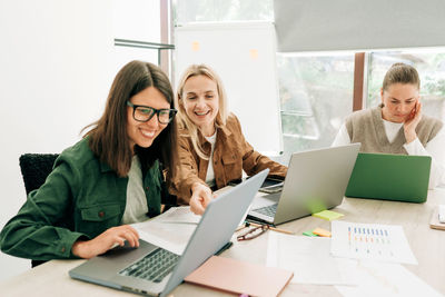 Businesswoman using laptop at office