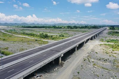 Scenic view of road by land against sky