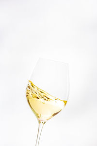 Close-up of beer glass against white background