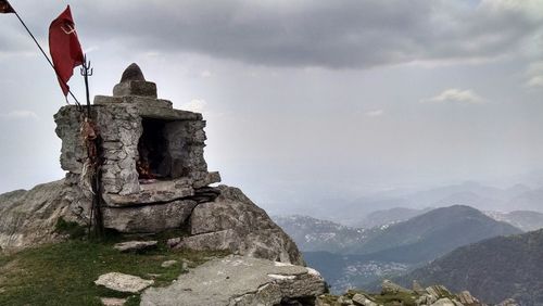 Scenic view of mountains against cloudy sky