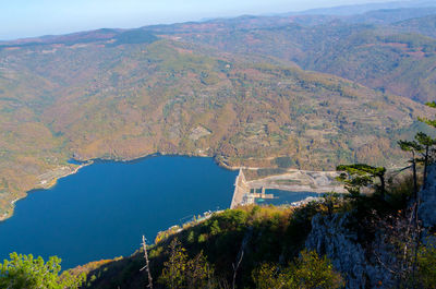 High angle view of lake and mountains against sky