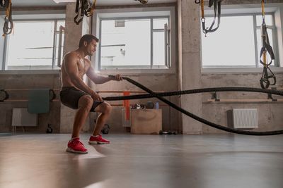 Side view of woman exercising in gym