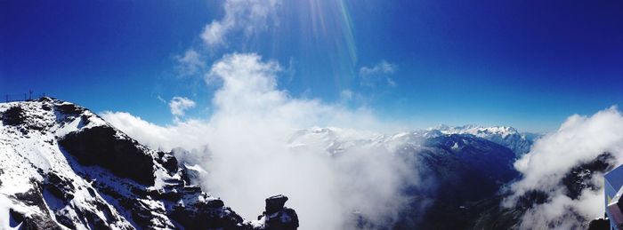 Low angle view of snow mountains against clear blue sky