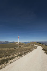 Road by land against sky