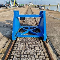 Empty bench on footpath by street