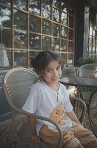 Portrait of girl sitting on seat