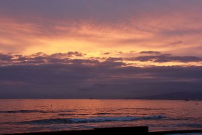 Scenic view of sea against romantic sky at sunset