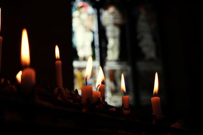 Close-up of burning candles in temple