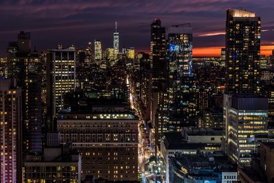 Illuminated cityscape against sky at night